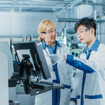 Laboratory scientists reviewing UV‑Vis protein concentration data using variable pathlength spectroscopy, demonstrating SoloVPE‑based efficiency gains over fixed pathlength methods.
