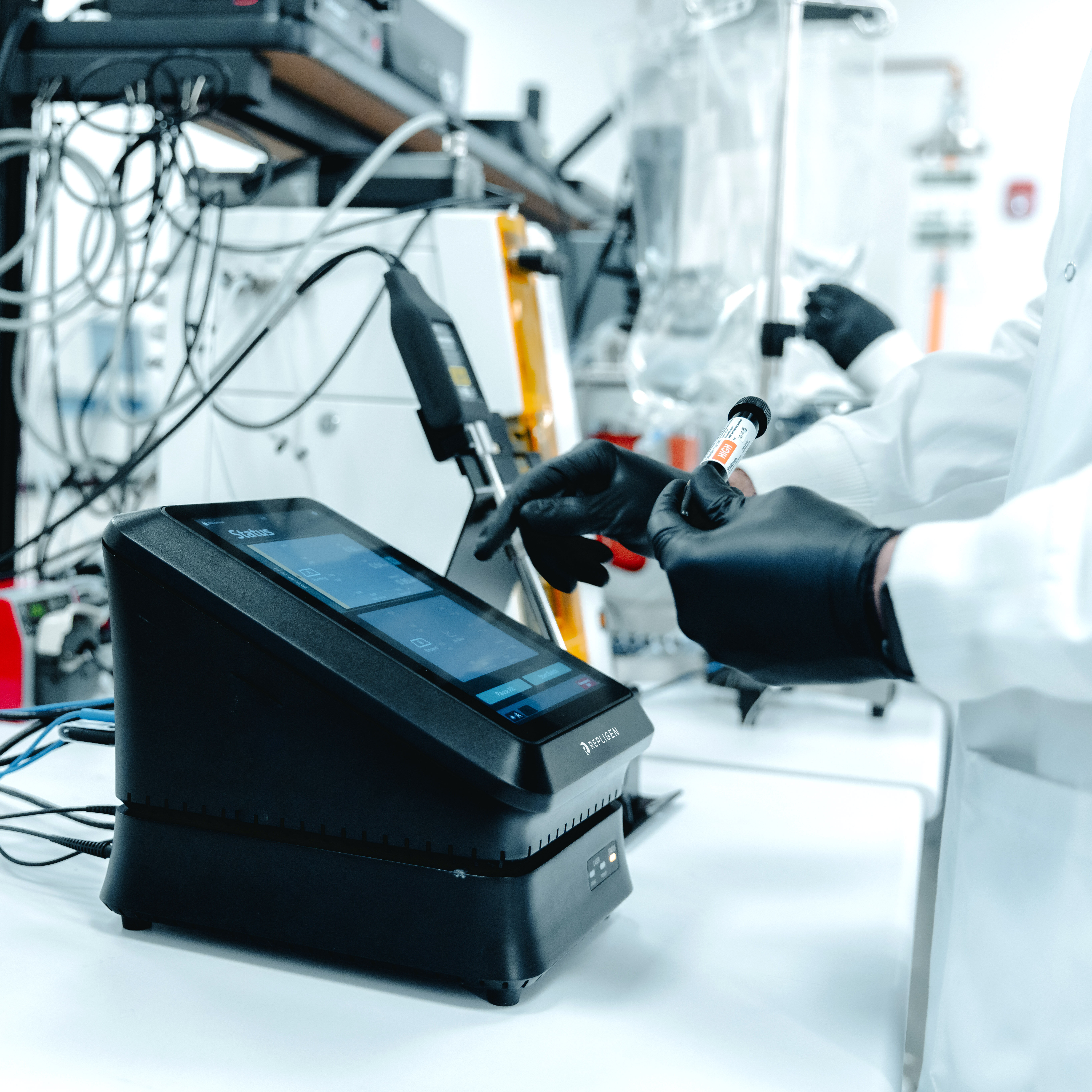  An image of a Quality Control (QC) or Quality Assurance (QA) member using the PATsmart MAVERICK In-line Critical Process Parameter Monitoring System, a process analytical technology (PAT) instrument, that utilizes a de novo approach to Raman spectrometry to measure glucose, lactate, and other critical process parameters (CPP).