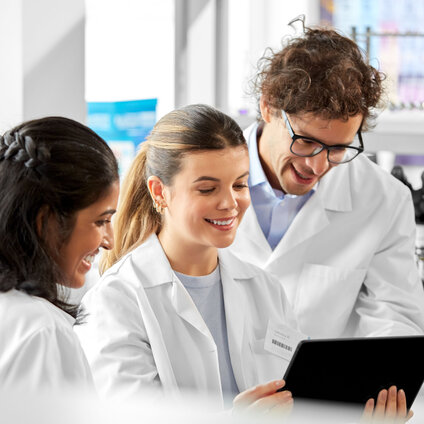 Three people in lab background