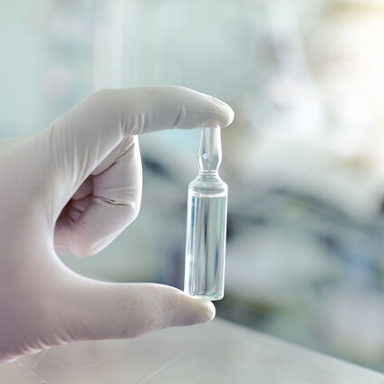 Close-up of vial, abstract background with parallel lines (peptide therapy ampule)
