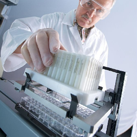 scientist installing RoboColumns into Tecan fluid handling station